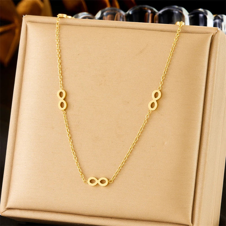 Parure bijoux femme infini doré collier et boucles assorties élégantes